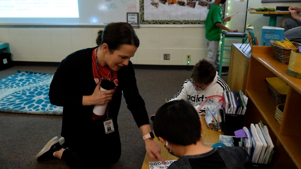 Teacher working with students