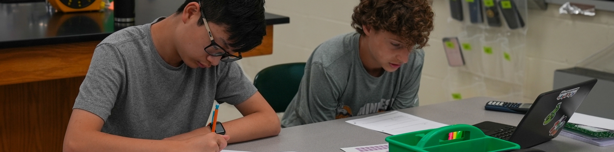 High school students working at a desk.