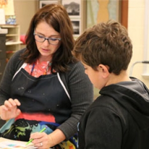 teacher helping student