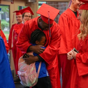 MSHS Senior hugs sibbling